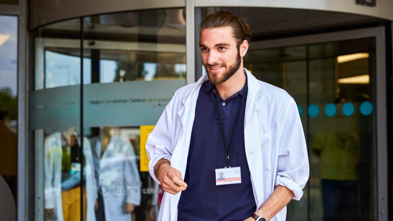A student standing outside a hospital.