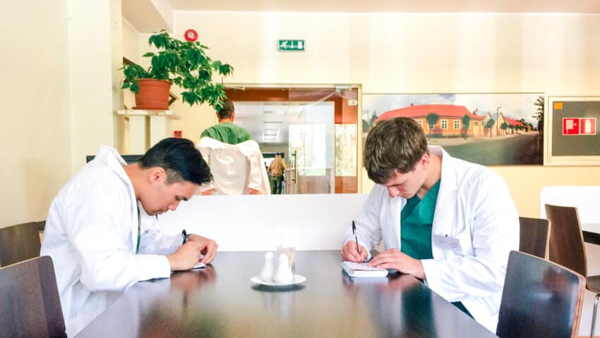 Students working on notes at a table.
