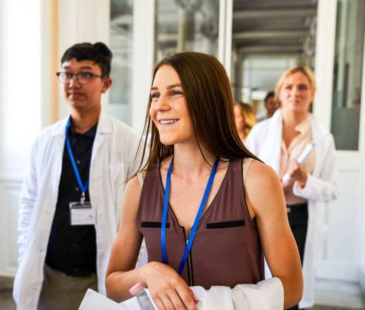 An Atlantis student smiling while walking through the hospital.